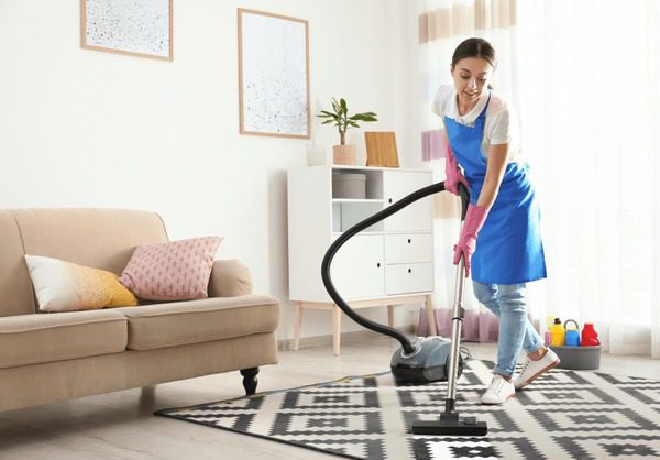 woman-hoovering-carpet-living-room-600nw-1430294426